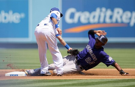 LOS ANGELES, CA - AUGUST 28:  Dexter Fowler #24 of the Colorado Rockies steals second base under the tag of second baseman Justin Sellers #12 of the Los Angeles Dodgers in the first inning during the MLB game at Dodger Stadium on August 28, 2011 in Los Angeles, California.  <br /><br /><span class="help">(Photo by Victor Decolongon/Getty Images)</span>