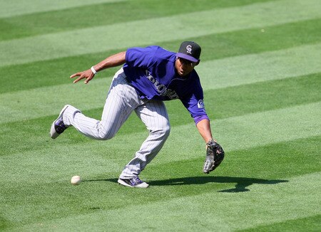 LOS ANGELES, CA - AUGUST 28:  Jonathan Herrera #19 of the Colorado Rockies fields a ground ball in the fourth inning during the MLB game against the Los Angeles Dodgers at Dodger Stadium on August 28, 2011 in Los Angeles, California.  <br /><br /><span class="help">(Photo by Victor Decolongon/Getty Images)</span>