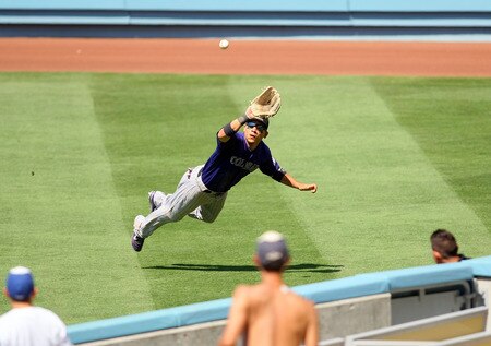 LOS ANGELES, CA - AUGUST 28:  Carlos Gonzalez #5 of the Colorado Rockies dives for a fly ball down the right field line in the fourth inning during the MLB game against the Los Angeles Dodgers at Dodger Stadium on August 28, 2011 in Los Angeles, California. The Rockies defeated the Dodgers 7-6. <br /><br /><span class="help">(Photo by Victor Decolongon/Getty Images)</span>