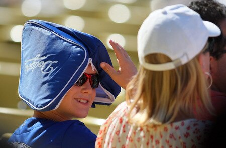 LOS ANGELES, CA - AUGUST 28:  A young Los Angeles Dodgers fan keeps cool with a Dodgers bag on his head during the MLB game between the Colorado Rockies and the Los Angeles Dodgers at Dodger Stadium on August 28, 2011 in Los Angeles, California.  The Rockies defeated the Dodgers 7-6.<br /><br /><span class="help">(Photo by Victor Decolongon/Getty Images)</span>
