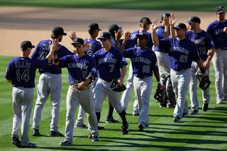 LOS ANGELES, CA - AUGUST 28:  Carlos Gonzalez #5 and Mark Ellis #14 of the Colorado Rockies and the rest of their teammates celebrate in the infield after defeating the Los Angeles Dodgers 7-6 in the MLB game at Dodger Stadium on August 28, 2011 in Los Angeles, California.  <br /><br /><span class="help">(Photo by Victor Decolongon/Getty Images)</span>