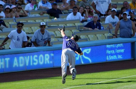 LOS ANGELES, CA - AUGUST 28:  Kevin Kouzmanoff #15 of the Colorado Rockies dives for a foul ball in the ninth inning during the MLB game against the Los Angeles Dodgers at Dodger Stadium on August 28, 2011 in Los Angeles, California. Kouzmanoff didn't make the catch. The Rockies defeated the Dodgers 7-6. <br /><br /><span class="help">(Photo by Victor Decolongon/Getty Images)</span>