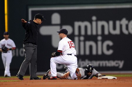 BOSTON, MA - SEPTEMBER 1:  Ed Rapuano calls Robinson Cano # 24 of the New York Yankees safe as Dustin Pedroia #15 of the Boston Red Sox looks on at Fenway Park on September 1, 2011 in Boston, Massachusetts. <br /><br /><span class="help">(Photo by Darren McCollester/Getty Images)</span>