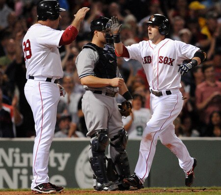 BOSTON, MA - SEPTEMBER 1:  Dustin Pedroia #15 of the Boston Red Sox gets congratulated by teamate Adrian Gonzalez #28 of the Boston Red Sox after hitting a two run homer in the fourth inning against the New York Yankees at Fenway Park on September 1, 2011 in Boston, Massachusetts. <br /><br /><span class="help">(Photo by Darren McCollester/Getty Images)</span>