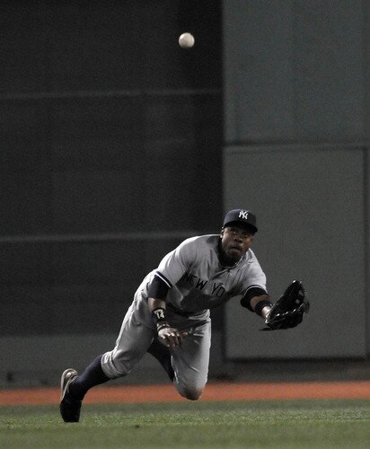 BOSTON, MA - SEPTEMBER 1:  Curtis Granderson #14 of the New York Yankees makes the diving catch to end the sixth inning against the Boston Red Sox at Fenway Park on September 1, 2011 in Boston, Massachusetts. <br /><br /><span class="help">(Photo by Darren McCollester/Getty Images)</span>