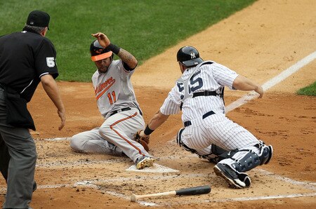 NEW YORK, NY - SEPTEMBER 05:  Robert Andino #11 of the Baltimore Orioles scores a second inning run ahead of the tag from Russell Martin #55 of the New York Yankees the on September 5, 2011 at Yankee Stadium in the Bronx borough of New York City.  <br /><br /><span class="help">(Photo by Jim McIsaac/Getty Images)</span>