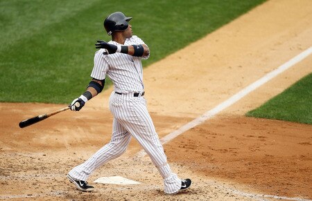 NEW YORK, NY - SEPTEMBER 05:  Robinson Cano #24 of the New York Yankees follows through on a second inning grand slam against the Baltimore Orioles on September 5, 2011 at Yankee Stadium in the Bronx borough of New York City.  <br /><br /><span class="help">(Photo by Jim McIsaac/Getty Images)</span>
