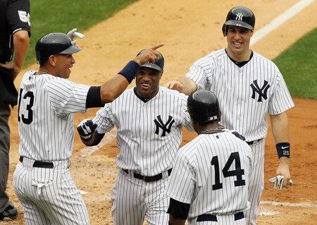 NEW YORK, NY - SEPTEMBER 05:  Robinson Cano #24 of the New York Yankees celebrates his second inning grand slam against the Baltimore Orioles with teammates Alex Rodriguez, Mark Teixeira #25 and Curtis Granderson #14 on September 5, 2011 at Yankee Stadium in the Bronx borough of New York City.  <br /><br /><span class="help">(Photo by Jim McIsaac/Getty Images)</span>