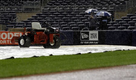 NEW YORK - SEPTEMBER 06:  Fans huddle under umbrellas during a rain delay before a scheduled game between the Baltimore Orioles and the New York Yankees at Yankee Stadium on September 6, 2011 in the Bronx Borough of New York City.  <br /><br /><span class="help">(Photo by Jeff Zelevansky/Getty Images)</span>