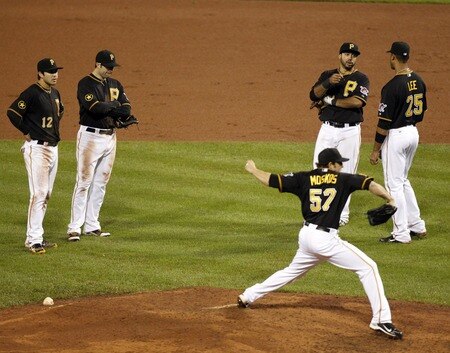 PITTSBURGH, PA - SEPTEMBER 06:  The Pirates infield of Chase D'Arnaud #12, Neil Walker #18, Pedro Alvarez #24 and Derrek Lee #25 talk while Daniel Moskos #57 warms up against the Houston Astros during the game on September 6, 2011 at PNC Park in Pittsburgh, Pennsylvania.  The Astros defeated the Pirates 4-1.  <br /><br /><span class="help">(Photo by Justin K. Aller/Getty Images)</span>