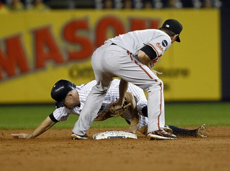 NEW YORK - SEPTEMBER 06:  Brett Gardner #11 of the New York Yankees steals second ahead of a throw to J.J. Hardy #2 of the Baltimore Orioles at Yankee Stadium on September 6, 2011 in the Bronx Borough of New York City.  <br /><br /><span class="help">(Photo by Jeff Zelevansky/Getty Images)</span>