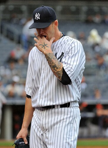 NEW YORK, NY - SEPTEMBER 07: A.J. Burnett #34 of the New York Yankees reacts as he walks back to the dugout after allowing two runs in the top of the third inning against the Baltimore Orioles on September 7, 2011 at Yankee Stadium in the Bronx borough of New York City. <br /><br /><span class="help">(Photo by Christopher Pasatieri/Getty Images)</span>