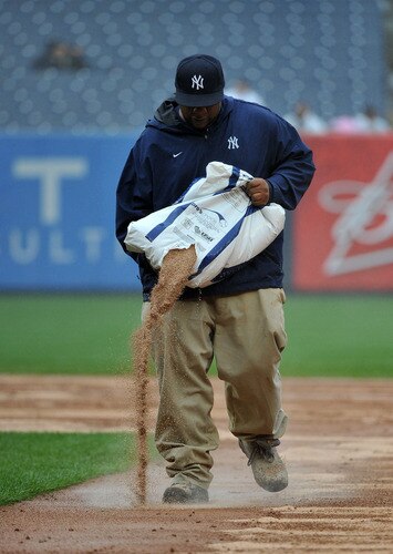 NEW YORK, NY - SEPTEMBER 07: A member of the New York Yankees grounds crew tends to the field in the middle of the sixth inning due to heavy rain during the game between the Baltimore Orioles and New York Yankees on September 7, 2011 at Yankee Stadium in the Bronx borough of New York City. <br /><br /><span class="help">(Photo by Christopher Pasatieri/Getty Images)</span>