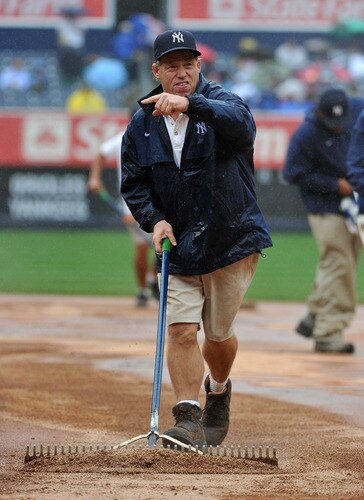 NEW YORK, NY - SEPTEMBER 07: A member of the New York Yankees grounds crew tends to the field in the middle of the sixth inning due to heavy rain during the game between the Baltimore Orioles and New York Yankees on September 7, 2011 at Yankee Stadium in the Bronx borough of New York City. <br /><br /><span class="help">(Photo by Christopher Pasatieri/Getty Images)</span>