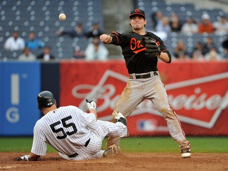 NEW YORK, NY - SEPTEMBER 07: Russell Martin #55 of the New York Yankees takes out Ryan Adams #6 of the Baltimore Orioles as he attempts to turn a double play in the bottom of the tenth inning on September 7, 2011 at Yankee Stadium in the Bronx borough of New York City. <br /><br /><span class="help">(Photo by Christopher Pasatieri/Getty Images)</span>