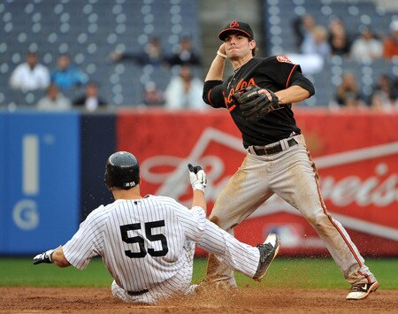 NEW YORK, NY - SEPTEMBER 07: Russell Martin #55 of the New York Yankees takes out Ryan Adams #6 of the Baltimore Orioles as he attempts to turn a double play in the bottom of the tenth inning on September 7, 2011 at Yankee Stadium in the Bronx borough of New York City. <br /><br /><span class="help">(Photo by Christopher Pasatieri/Getty Images)</span>