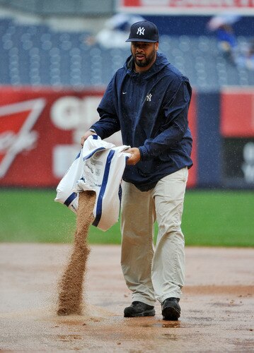 NEW YORK, NY - SEPTEMBER 07: A member of the New York Yankees grounds crew tends to the field in the middle of the sixth inning due to heavy rain during the game between the Baltimore Orioles and New York Yankees on September 7, 2011 at Yankee Stadium in the Bronx borough of New York City. <br /><br /><span class="help">(Photo by Christopher Pasatieri/Getty Images)</span>
