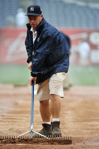 NEW YORK, NY - SEPTEMBER 07: A member of the New York Yankees grounds crew tends to the field in the middle of the sixth inning due to heavy rain during the game between the Baltimore Orioles and New York Yankees on September 7, 2011 at Yankee Stadium in the Bronx borough of New York City. <br /><br /><span class="help">(Photo by Christopher Pasatieri/Getty Images)</span>