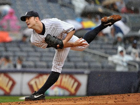 NEW YORK, NY - SEPTEMBER 07: David Robertson #30 of the New York Yankees throws a pitch in the rain during the top of the eighth inning against the Baltimore Orioles and New York Yankees on September 7, 2011 at Yankee Stadium in the Bronx borough of New York City. <br /><br /><span class="help">(Photo by Christopher Pasatieri/Getty Images)</span>