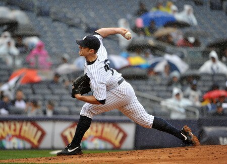 NEW YORK, NY - SEPTEMBER 07: David Robertson #30 of the New York Yankees throws a pitch in the rain during the top of the eighth inning against the Baltimore Orioles and New York Yankees on September 7, 2011 at Yankee Stadium in the Bronx borough of New York City. <br /><br /><span class="help">(Photo by Christopher Pasatieri/Getty Images)</span>