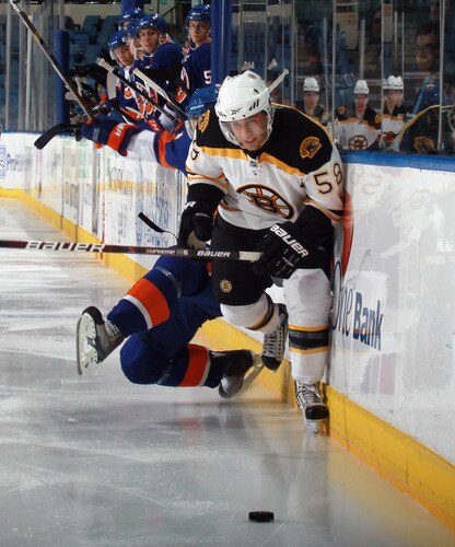UNIONDALE, NY - SEPTEMBER 12: Carter Camper #58 of the Boston Bruins moves past Calvin de Haan #24 of the New York Islanders during a rookie game exhibition at Nassau Coliseum on September 12, 2011 in Uniondale, New York.  <br /><br /><span class="help">(Photo by Bruce Bennett/Getty Images)</span>