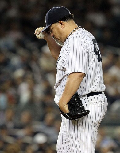 NEW YORK, NY - SEPTEMBER 22:  Bartolo Colon #40 of the New York Yankees reacts after surrendering a third-inning two-run home run against the Tampa Bay Rays on September 22, 2011 at Yankee Stadium in the Bronx borough of New York City.  <br /><br /><span class="help">(Photo by Jim McIsaac/Getty Images)</span>