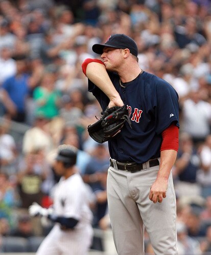 NEW YORK, NY - SEPTEMBER 24:  Jon Lester #31 of the Boston Red Sox wipes sweat from his face as Derek Jeter #2  of the New York Yankees rounds the bases after his three RBI home run on September 24, 2011 at Yankee Stadium in the Bronx borough of New York City.  <br /><br /><span class="help">(Photo by Nick Laham/Getty Images)</span>