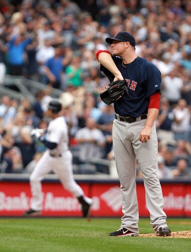 NEW YORK, NY - SEPTEMBER 24:  Jon Lester #31 of the Boston Red Sox wipes sweat from his face as Derek Jeter #2  of the New York Yankees rounds the bases after his three RBI home run on September 24, 2011 at Yankee Stadium in the Bronx borough of New York City.  <br /><br /><span class="help">(Photo by Nick Laham/Getty Images)</span>