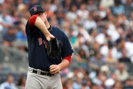 NEW YORK, NY - SEPTEMBER 24:  Jon Lester #31 of the Boston Red Sox wipes sweat from his face against the New York Yankees on September 24, 2011 at Yankee Stadium in the Bronx borough of New York City.  <br /><br /><span class="help">(Photo by Nick Laham/Getty Images)</span>