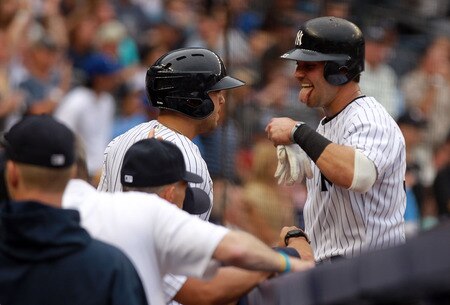 NEW YORK, NY - SEPTEMBER 24: Nick Swisher #33 of the New York Yankees celebrates scoring a run in the second inning as he enters the dugout against the Boston Red Sox on September 24, 2011 at Yankee Stadium in the Bronx borough of New York City.  <br /><br /><span class="help">(Photo by Nick Laham/Getty Images)</span>