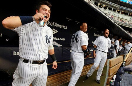 NEW YORK, NY - SEPTEMBER 24:  Nick Swisher #33, Robinson Cano #24 and Andruw Jones #18 of the New York Yankees stand in the dugout prior to the game against the Boston Red Sox on September 24, 2011 at Yankee Stadium in the Bronx borough of New York City.  <br /><br /><span class="help">(Photo by Nick Laham/Getty Images)</span>