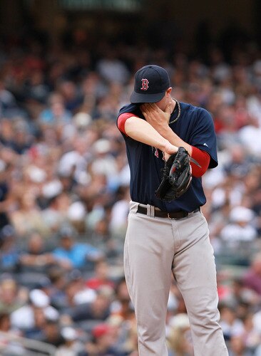 NEW YORK, NY - SEPTEMBER 24:  Jon Lester #31 of the Boston Red Sox wipes sweat from his face against the New York Yankees on September 24, 2011 at Yankee Stadium in the Bronx borough of New York City.  <br /><br /><span class="help">(Photo by Nick Laham/Getty Images)</span>