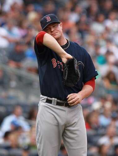 NEW YORK, NY - SEPTEMBER 24:  Jon Lester #31 of the Boston Red Sox wipes sweat from his face against the New York Yankees on September 24, 2011 at Yankee Stadium in the Bronx borough of New York City.  <br /><br /><span class="help">(Photo by Nick Laham/Getty Images)</span>