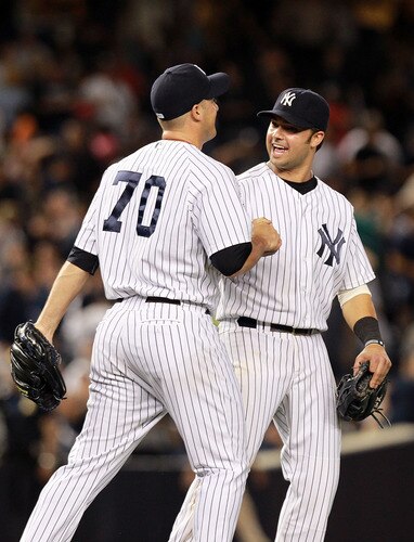 NEW YORK, NY - SEPTEMBER 24: Nick Swisher #33 of the New York Yankees celebrates the win with George Kontos #70 against the Boston Red Sox on September 24, 2011 at Yankee Stadium in the Bronx borough of New York City.  <br /><br /><span class="help">(Photo by Nick Laham/Getty Images)</span>