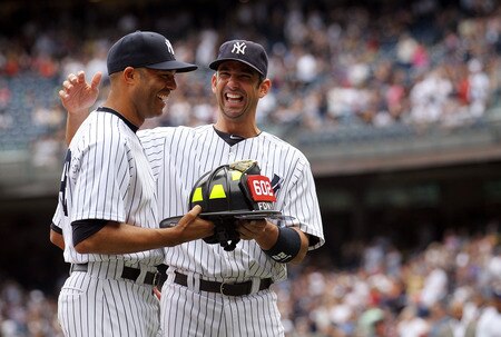 NEW YORK, NY - SEPTEMBER 25: Jorge Posada #20 of the New York Yankees presents Mariano Rivera #42 with a FDNY fire helmet during a ceremony to celebrate his record 602 career save prior to the game against the Boston Red Sox on September 25, 2011 at Yankee Stadium in the Bronx borough of New York City.  <br /><br /><span class="help">(Photo by Nick Laham/Getty Images)</span>