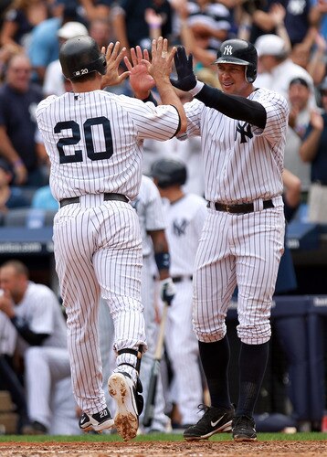 NEW YORK, NY - SEPTEMBER 25:  Jorge Posada #20 of the New York Yankees celebrates hitting a 2 RBI home run in the third inning with scoring runner Alex Rodriguez #13 against the Boston Red Sox on September 25, 2011 at Yankee Stadium in the Bronx borough of New York City.  <br /><br /><span class="help">(Photo by Nick Laham/Getty Images)</span>
