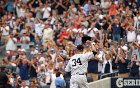 NEW YORK, NY - SEPTEMBER 25:  A.J. Burnett #34 of the New York Yankees salutes the crowd as he leaves the game in the eighth inning against the Boston Red Sox on September 25, 2011 at Yankee Stadium in the Bronx borough of New York City.  <br /><br /><span class="help">(Photo by Nick Laham/Getty Images)</span>