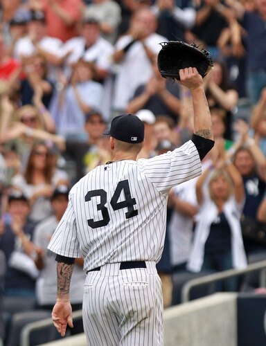 NEW YORK, NY - SEPTEMBER 25:  A.J. Burnett #34 of the New York Yankees salutes the crowd as he leaves the game in the eighth inning against the Boston Red Sox on September 25, 2011 at Yankee Stadium in the Bronx borough of New York City.  <br /><br /><span class="help">(Photo by Nick Laham/Getty Images)</span>