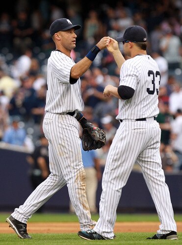 NEW YORK, NY - SEPTEMBER 25: Derek Jeter #2 of the New York Yankees celebrates the win with teammate Nick Swisher #33 against the Boston Red Sox on September 25, 2011 at Yankee Stadium in the Bronx borough of New York City.  <br /><br /><span class="help">(Photo by Nick Laham/Getty Images)</span>