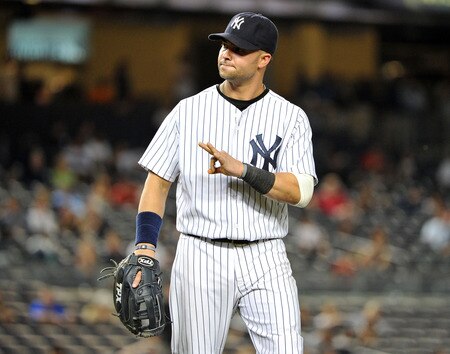 NEW YORK, NY - SEPTEMBER 25: Nick Swisher #33 of the New York Yankees motions towards the dugout after Dustin Pedroia #15 of the Boston Red Sox (not pictured) was called safe sliding in to first base in the top of the 13th inning on September 25, 2011 at Yankee Stadium in the Bronx borough of New York City. <br /><br /><span class="help">(Photo by Christopher Pasatieri/Getty Images)</span>