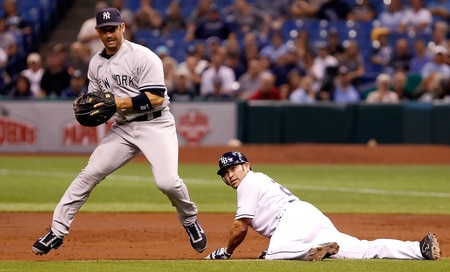 ST. PETERSBURG, FL - SEPTEMBER 26:  First baseman Jorge Posada #20 of the New York Yankees throws home after the put out of Johnny Damon #22 of the Tampa Bay Rays during the game at Tropicana Field on September 26, 2011 in St. Petersburg, Florida.  <br /><br /><span class="help">(Photo by J. Meric/Getty Images)</span>
