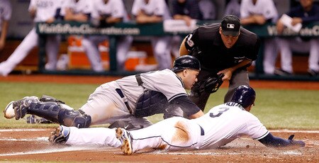 ST PETERSBURG, FL - SEPTEMBER 26:  Catcher Russell Martin #55 of the New York Yankees makes the tag on Evan Longoria #3 of the Tampa Bay Rays during the game at Tropicana Field on September 26, 2011 in St. Petersburg, Florida.  <br /><br /><span class="help">(Photo by J. Meric/Getty Images)</span>