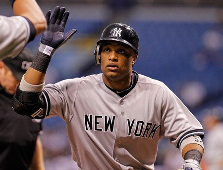 ST. PETERSBURG, FL - SEPTEMBER 26:  Infielder Robinson Cano #24 of the New York Yankees is congratulated after his first inning home run against the Tampa Bay Rays during the game at Tropicana Field on September 26, 2011 in St. Petersburg, Florida.  <br /><br /><span class="help">(Photo by J. Meric/Getty Images)</span>