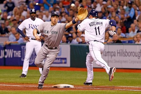ST. PETERSBURG, FL - SEPTEMBER 28:  Casey Kotchman #11 of the Tampa Bay Rays beats out an infield hit as first baseman Mark Teixeira #25 of the New York Yankees stretches for the throw during the game at Tropicana Field on September 28, 2011 in St. Petersburg, Florida.  <br /><br /><span class="help">(Photo by J. Meric/Getty Images)</span>