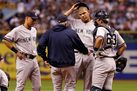 ST. PETERSBURG, FL - SEPTEMBER 28:  Pitching coach Larry Rothschild #58 of the New York Yankees talks with pitcher Dellin Betances #68 during the game against the Tampa Bay Rays at Tropicana Field on September 28, 2011 in St. Petersburg, Florida.  <br /><br /><span class="help">(Photo by J. Meric/Getty Images)</span>