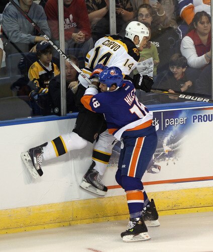 BRIDGEPORT, CT - OCTOBER 01:  Michael Haley #18 of the New York Islanders boards Joe Corvo #14 of the Boston Bruins at the Webster Bank Arena on October 1, 2011 in Bridgeport, Connecticut.  <br /><br /><span class="help">(Photo by Bruce Bennett/Getty Images)</span>