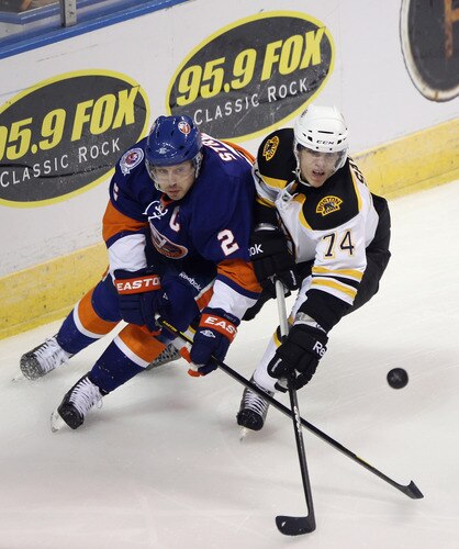 BRIDGEPORT, CT - OCTOBER 01:  Mark Streit #2 of the New York Islanders and Max Sauve #74 of the Boston Bruins battle for the puck at the Webster Bank Arena on October 1, 2011 in Bridgeport, Connecticut.  <br /><br /><span class="help">(Photo by Bruce Bennett/Getty Images)</span>