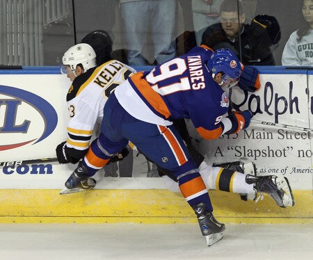 BRIDGEPORT, CT - OCTOBER 01: John Tavares #91 of the New York Islanders hits Chris Kelly #23 of the Boston Bruins into the boards at the Webster Bank Arena on October 1, 2011 in Bridgeport, Connecticut.  <br /><br /><span class="help">(Photo by Bruce Bennett/Getty Images)</span>