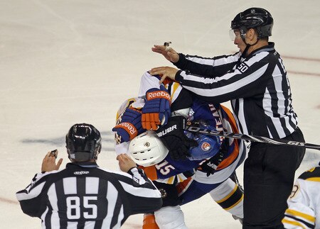 BRIDGEPORT, CT - OCTOBER 01: P.A Parenteau #15 of the New York Islanders wrestles with Brad Marchand #63 of the Boston Bruins following Marchand's hit on John Tavares at the Webster Bank Arena on October 1, 2011 in Bridgeport, Connecticut.  <br /><br /><span class="help">(Photo by Bruce Bennett/Getty Images)</span>