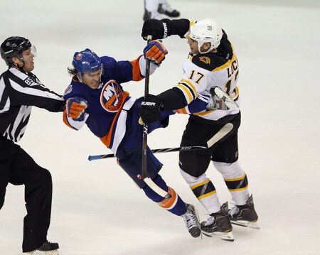 BRIDGEPORT, CT - OCTOBER 01:  P.A. Parenteau #15 of the New York Islanders is hit by Milan Lucic #17 of the Boston Bruins at the Webster Bank Arena on October 1, 2011 in Bridgeport, Connecticut. The Bruins defeated the Islanders 3-2.  <br /><br /><span class="help">(Photo by Bruce Bennett/Getty Images)</span>